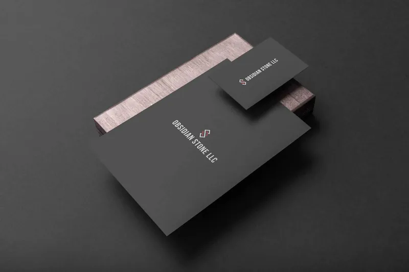 Premium dark brand identity — stationery system on textured backdrop